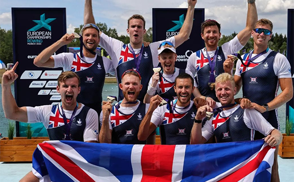 A group of male rowers celebrating their win at the European Championships